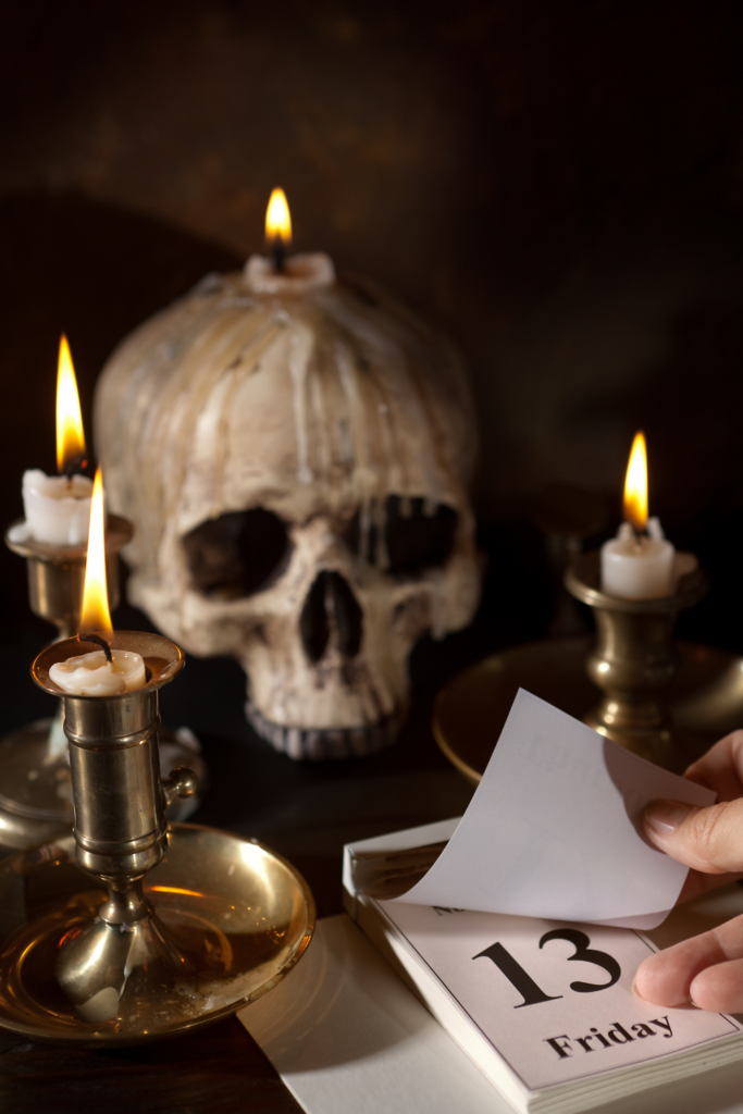 Stock photo from Canva by Anyka of a skull candle holder and a desk calendar displaying Friday 13th