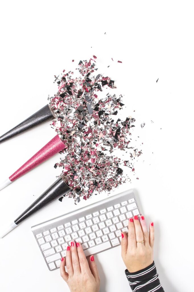 Stock image for Blogging Goals for 2016 on Thelifeofaglasgowgirl.co.uk birds eye view of a silver keyboard on a white desk with glitter around it