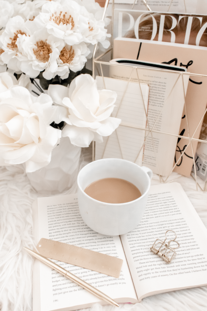 Stock photo for My Break From Blogging on Thelifeofaglasgowgirl.co.uk Photo of a white mug on a table with books and white flowers