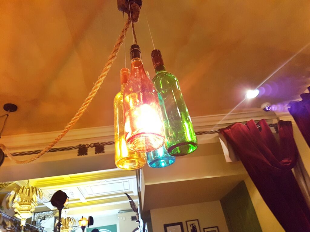 Quirky Lights Close up of some lights in The Trading House Glasgow. The light shades are made out of glass bottles.