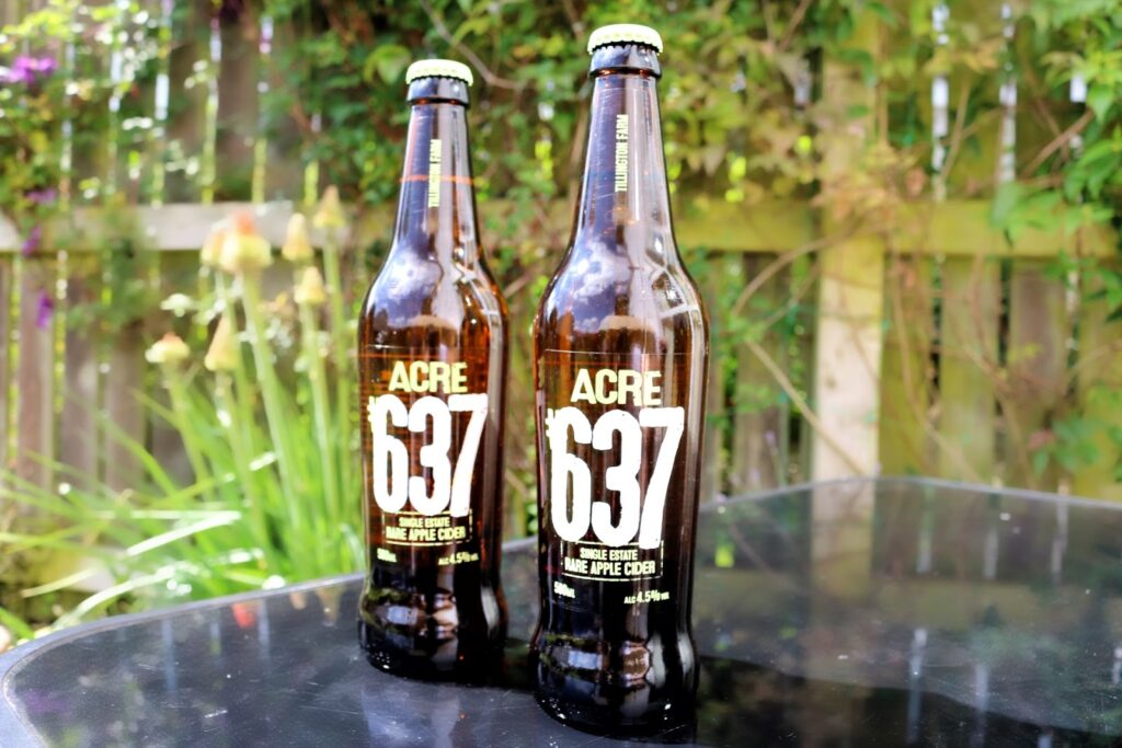 Close up phot of two rare apple cider bottles from ACRE