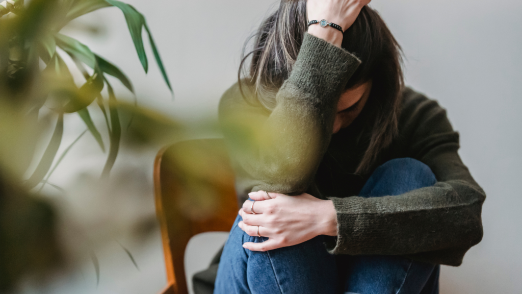 Close up of a woman upset holding her head in her hands