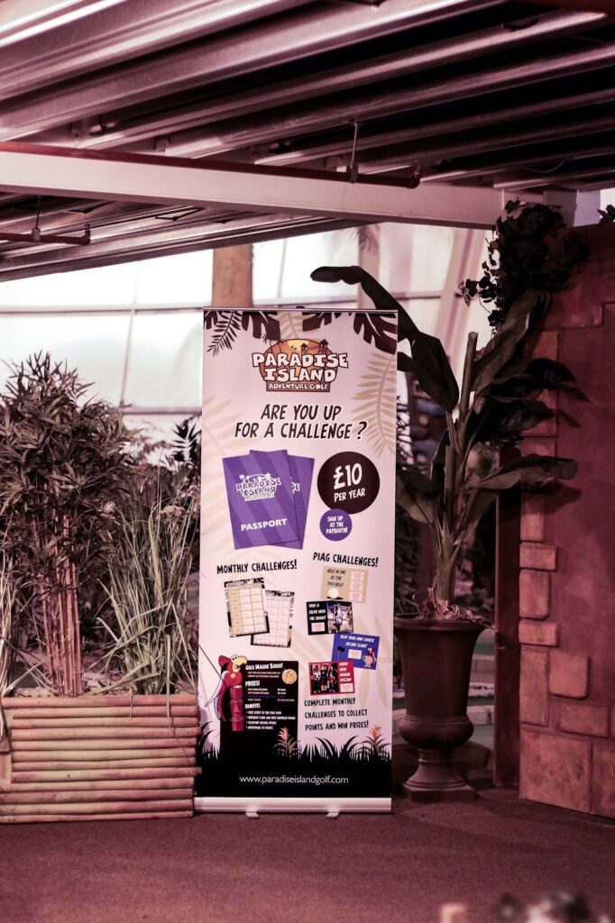 Close up of an advertisement board for Paradise Island Adventure Golf in Glasgow