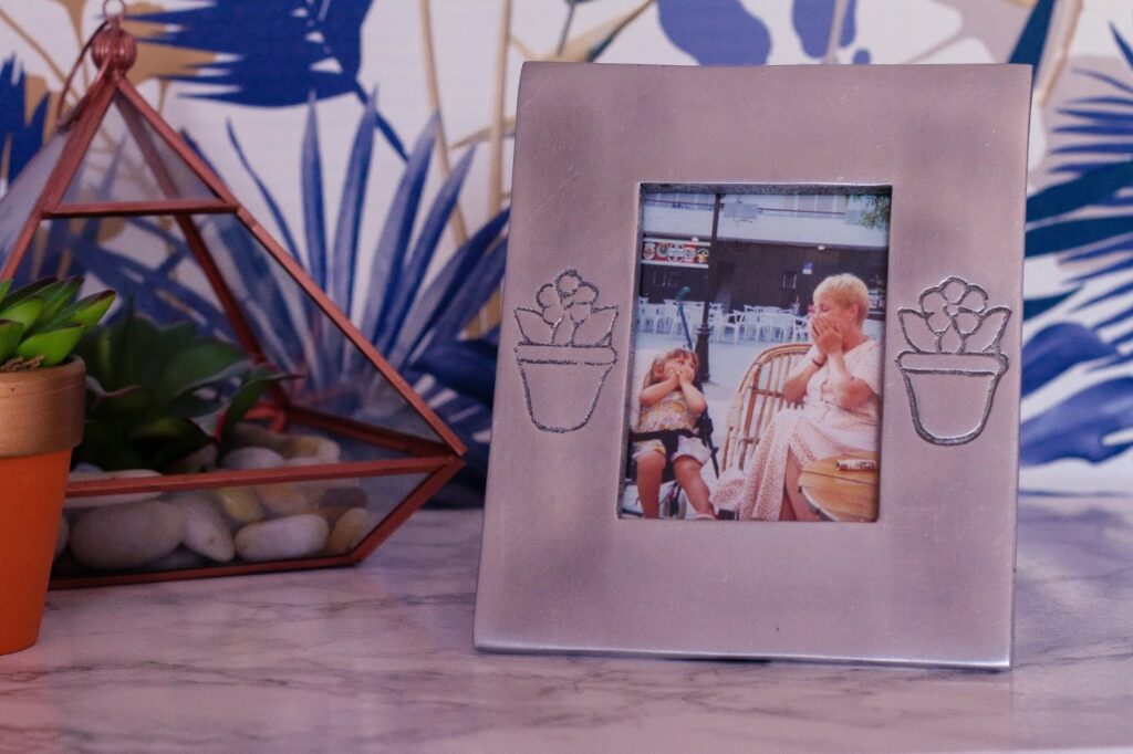Close up of a photo in a frame on thelifeofaglasgowgirl.co.uk Close up of a photo in a frame sitting on a white marble desk with a small green indoor plant behind it on thelifeofaglasgowgirl.co.uk