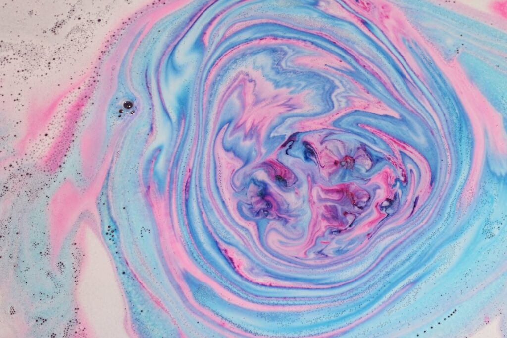 Close up of Monsters' Ball fizzing out pink and blue in the water