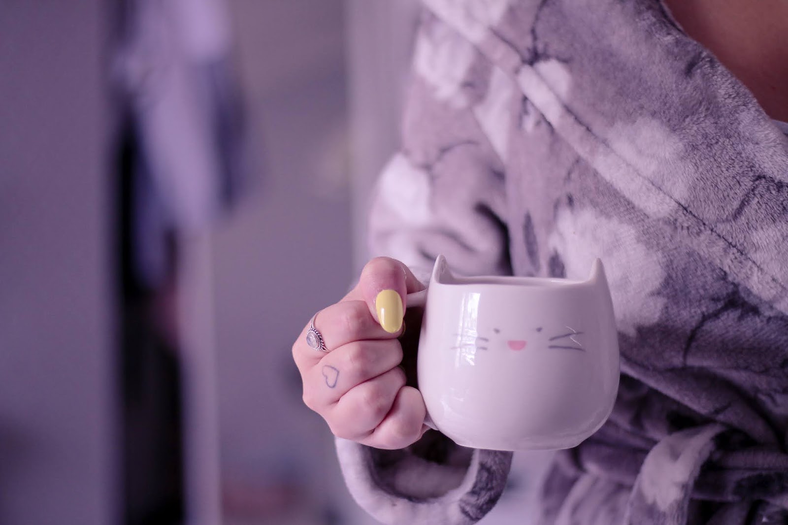 August To Do main blog post image on Thelifeofaglasgowgirl.co.uk Medium close up shot of a girl in a grey robe holding a white cat mug