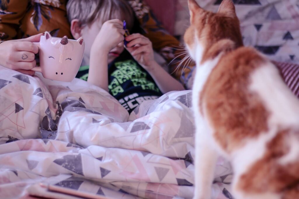 Close up of Jordanne cuddling her son. His face is hidden behind his arms