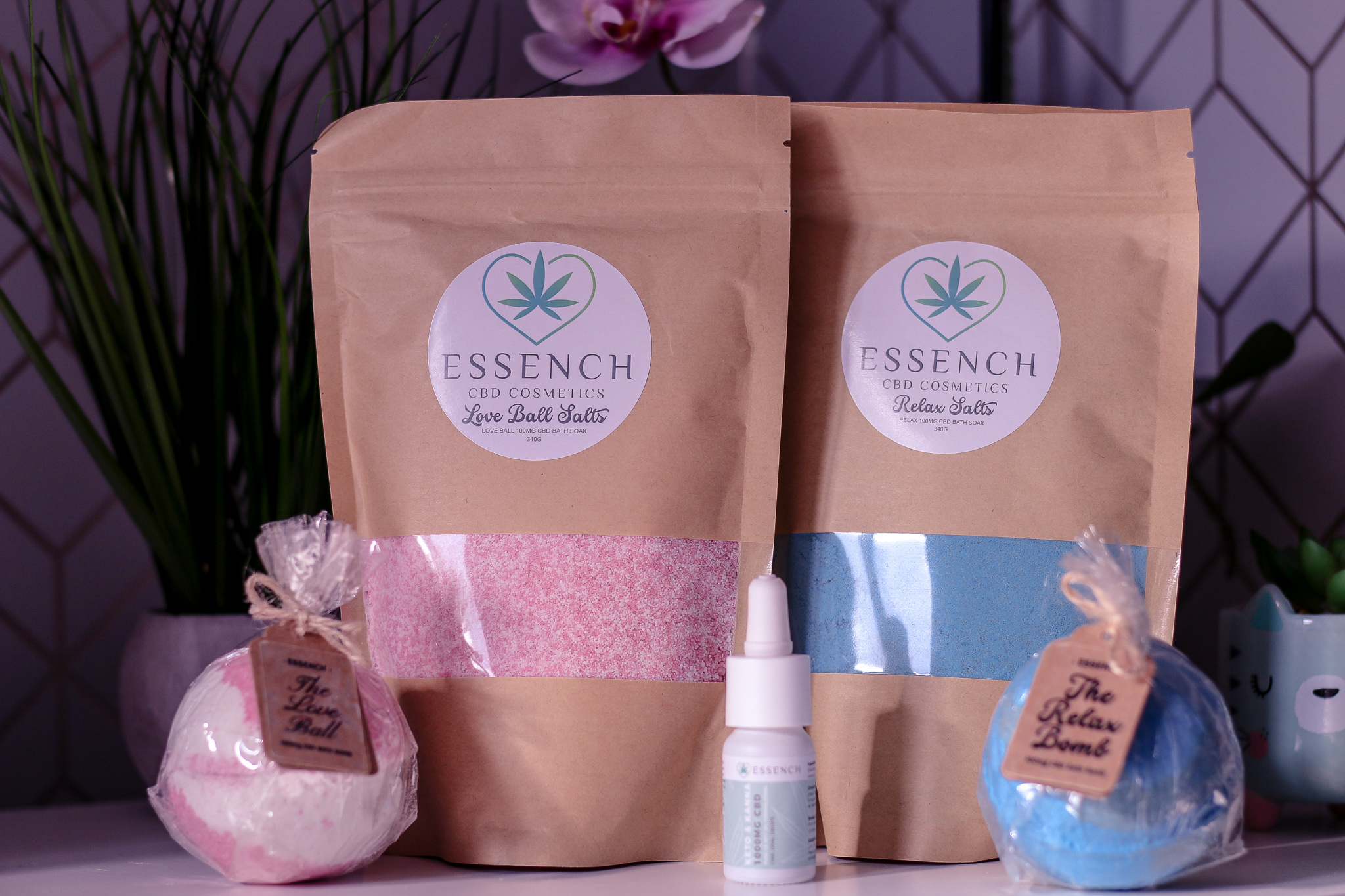 National Women's Health and Fitness day with ESSENCH A photo of 4 ESSENCH CBD products sitting on a white bedside table