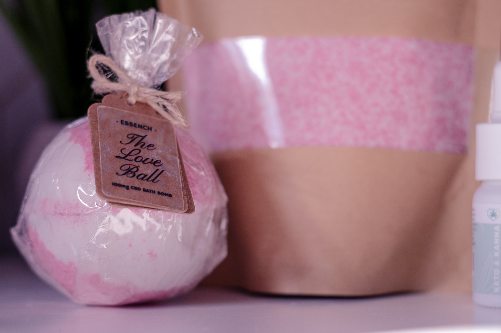 National Women's Health and Fitness day with ESSENCH Close up photo of The Love Bug CBD bath bomb from ESSENCH