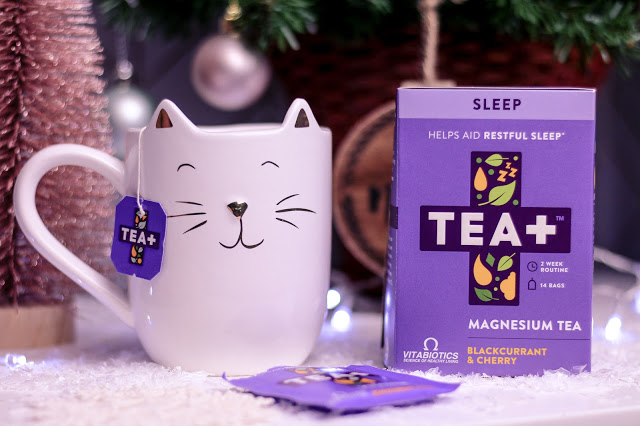 Close up of a white cat mug and the Tea+ sleep tea