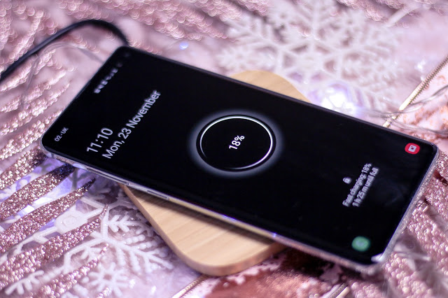 Close up of a Samsung S10+ charging on the Always Personal bamboo phone charging pad
