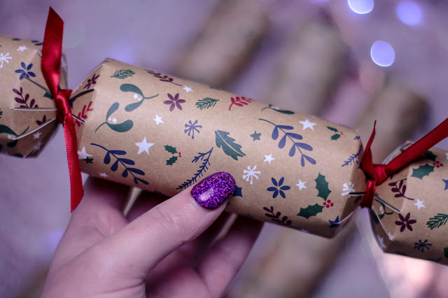 Close up of a woman holding a Love Tiki Christmas Cracker