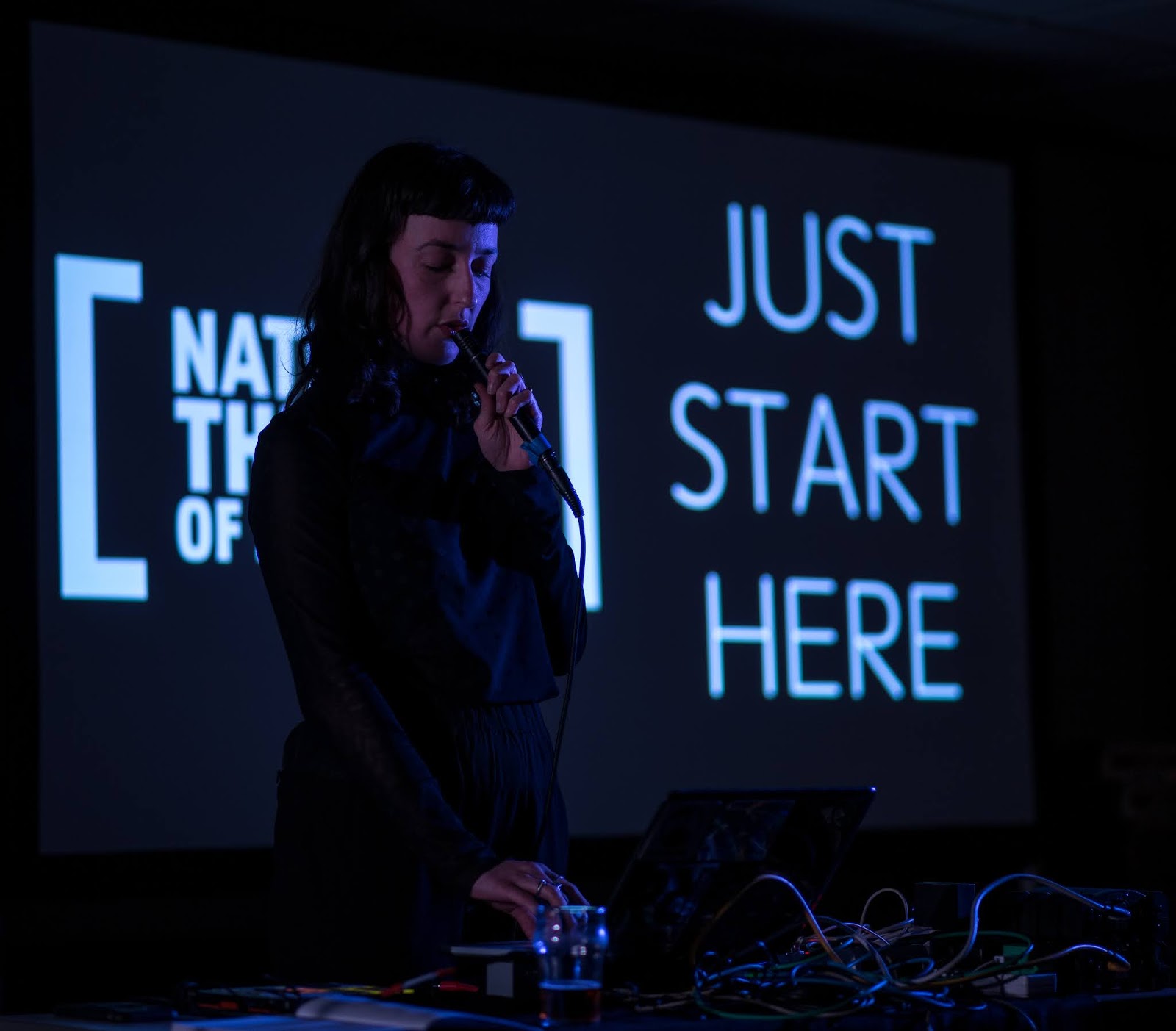 Photo if a woman performing at the Just start here festival by National theatre - Photo by Jordanne lee creative Photo if a woman performing on stage at the Just start here festival by National theatre 2020 - Photo by Jordanne lee creative