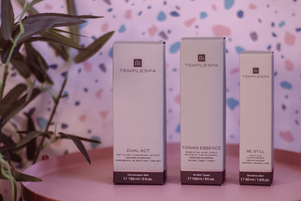 A close up photo of the My Kinda Skin Essentials From TEMPLESPA. Pictured is the Dual Act cleanser, Be still Settling moisturiser and Toning essence packaging