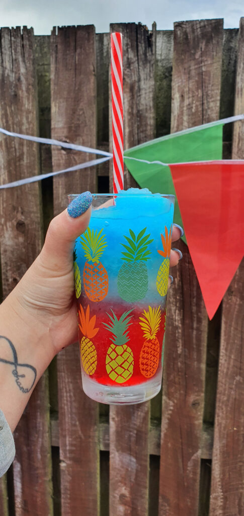 Close up of a blue and red cocktail 