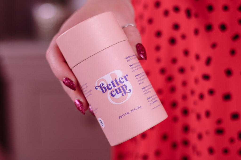 Close up photo of woman holding Better Cup menstrual cup packaging