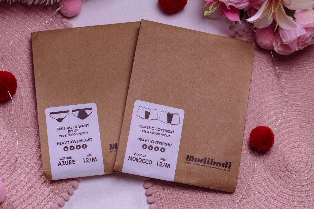 Birds eye photo of two packs of Modibodi period and leak proof underwear