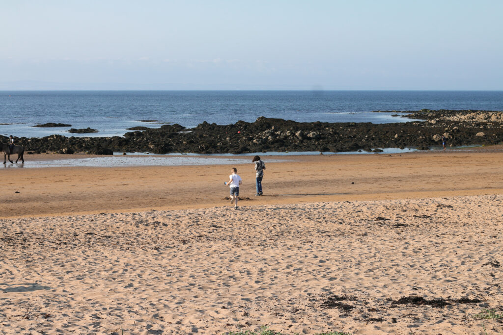Wild Camping at Yellowcraigs beach in Scotland - The children running on the beach