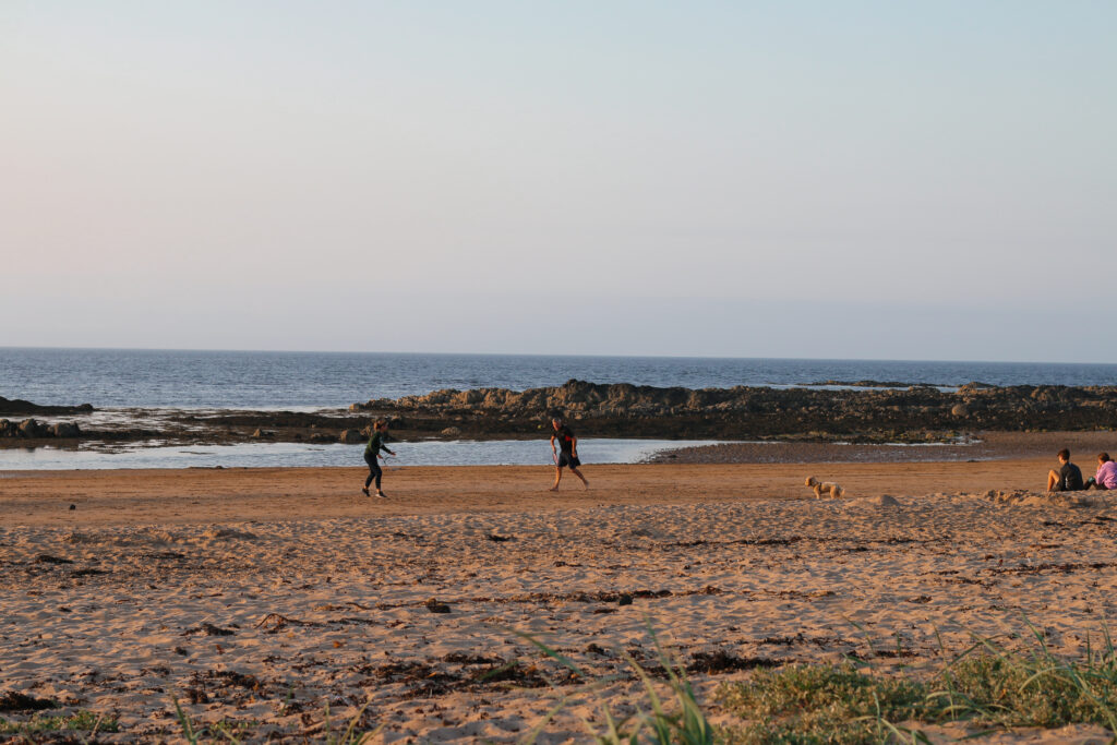 Wild Camping at Yellowcraigs beach in Scotland - View of people playing tennis on the beach