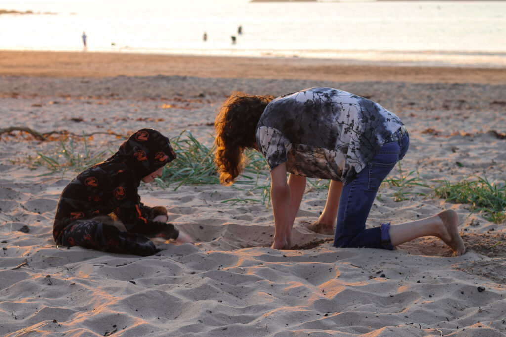 July Roundup - Photo of two children playing in the sand
