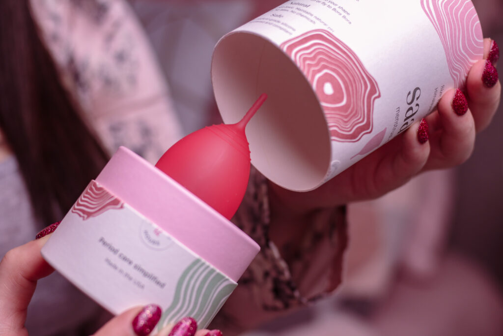 Woman opening the Saalt Menstrual Cup