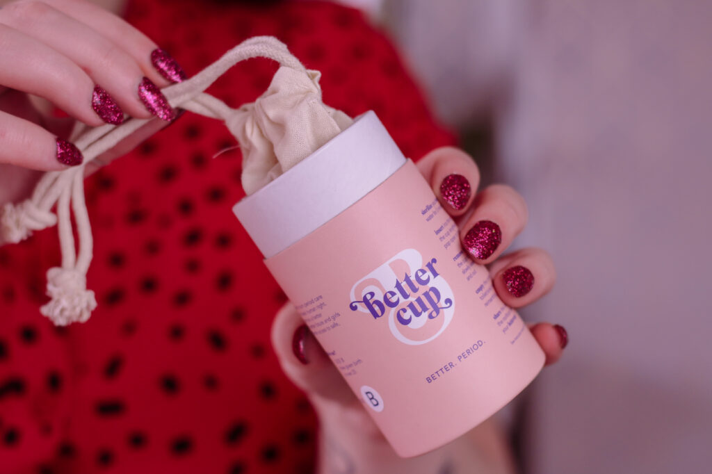 Close up photo of woman opening Better Cup menstrual cup box