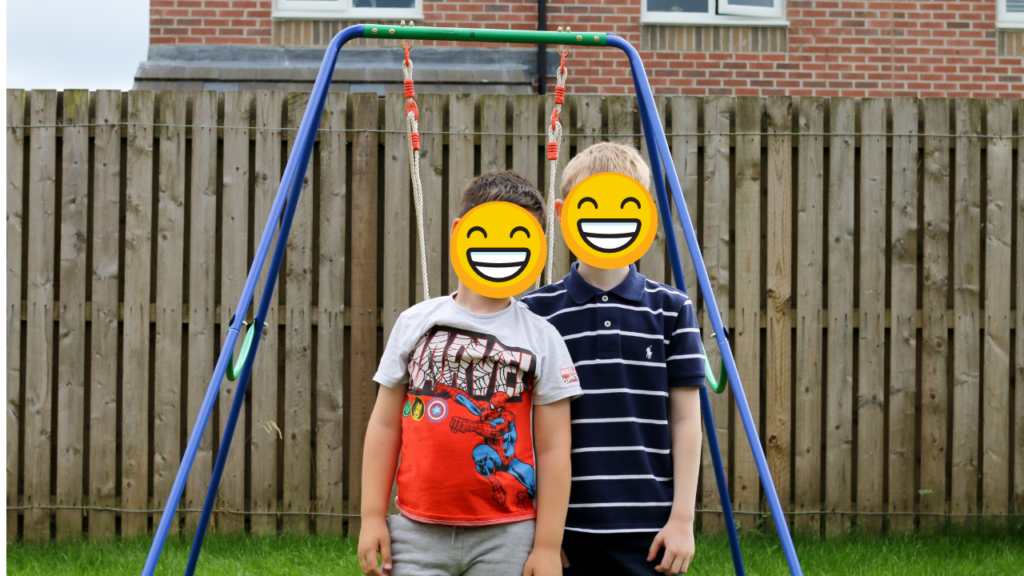 Medium close up photo of two children in a garden