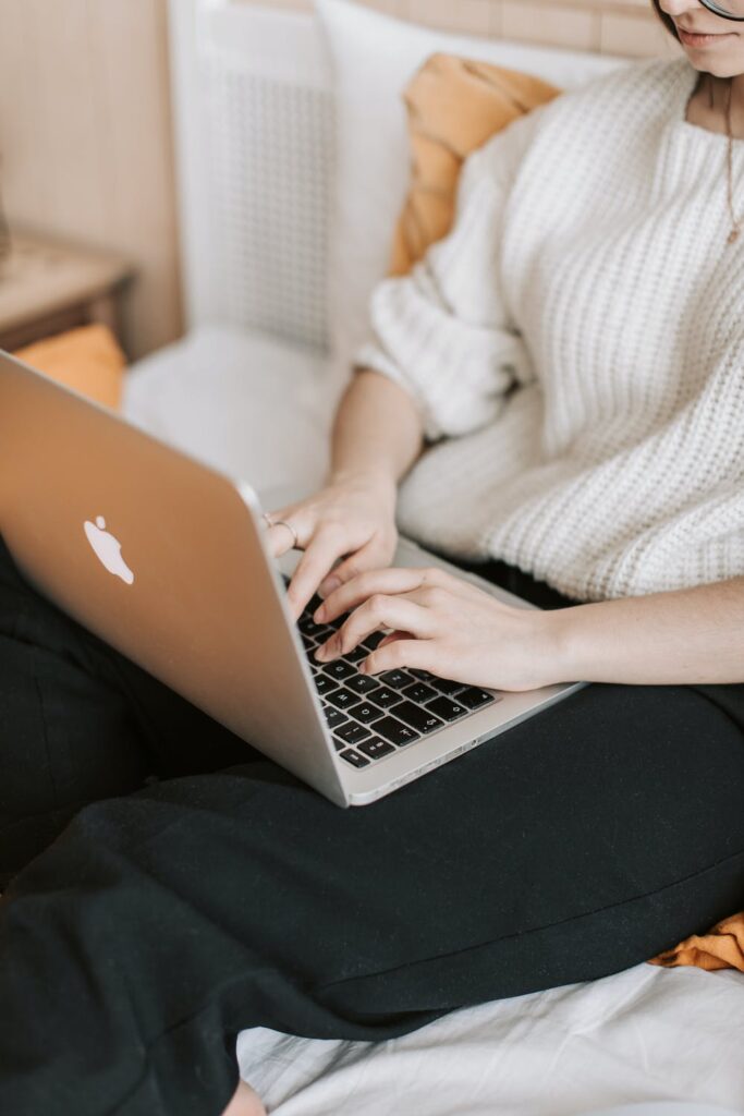 What Makes You Successful - Stock photo from pexels by Vlada Karpovich of a woman on an apple laptop wearing a white knit jumper