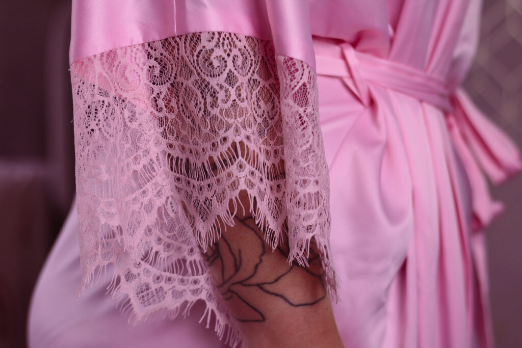 Extreme close up of sleeve of pink dressing gown.