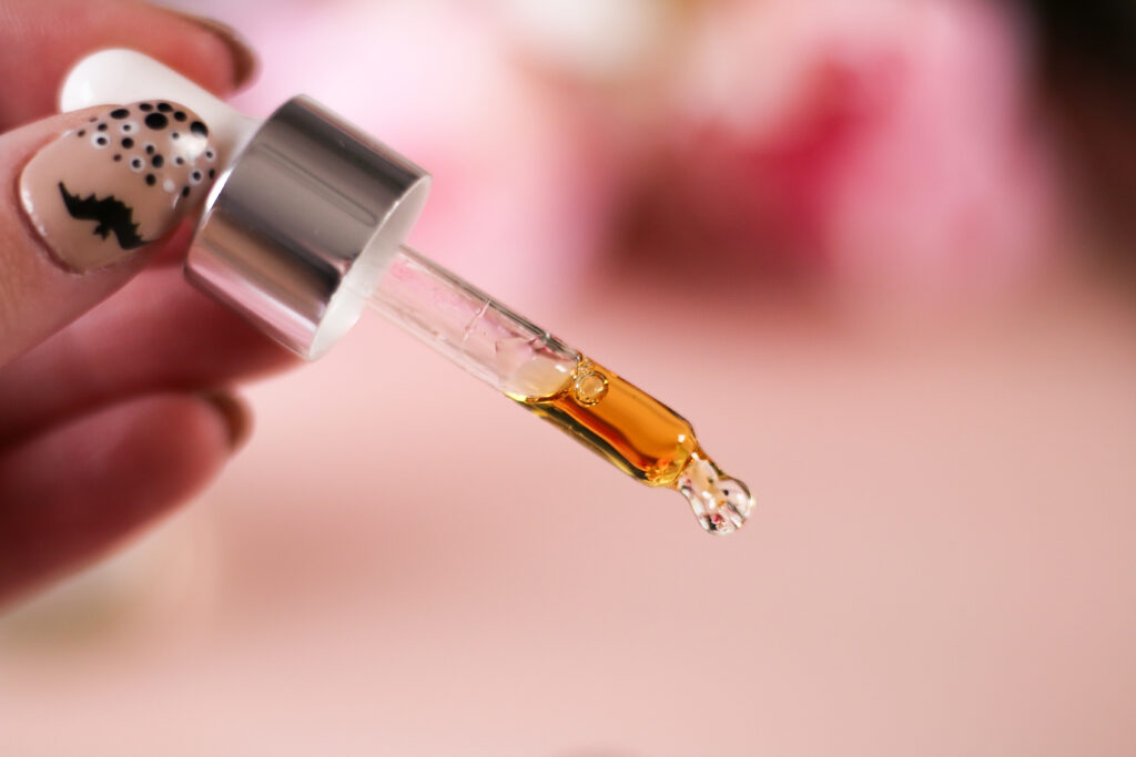 Close up photo of a dropper with CBD oil in it