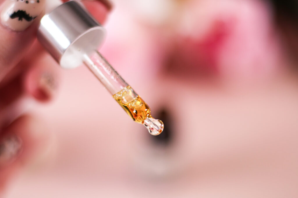 Close up photo of a dropper with CBD oil in it