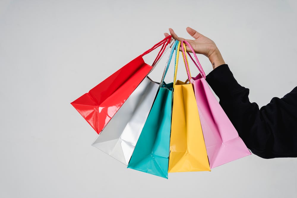 stock photo from pexels by Sora Shimazaki of 5 gift bags in a hand