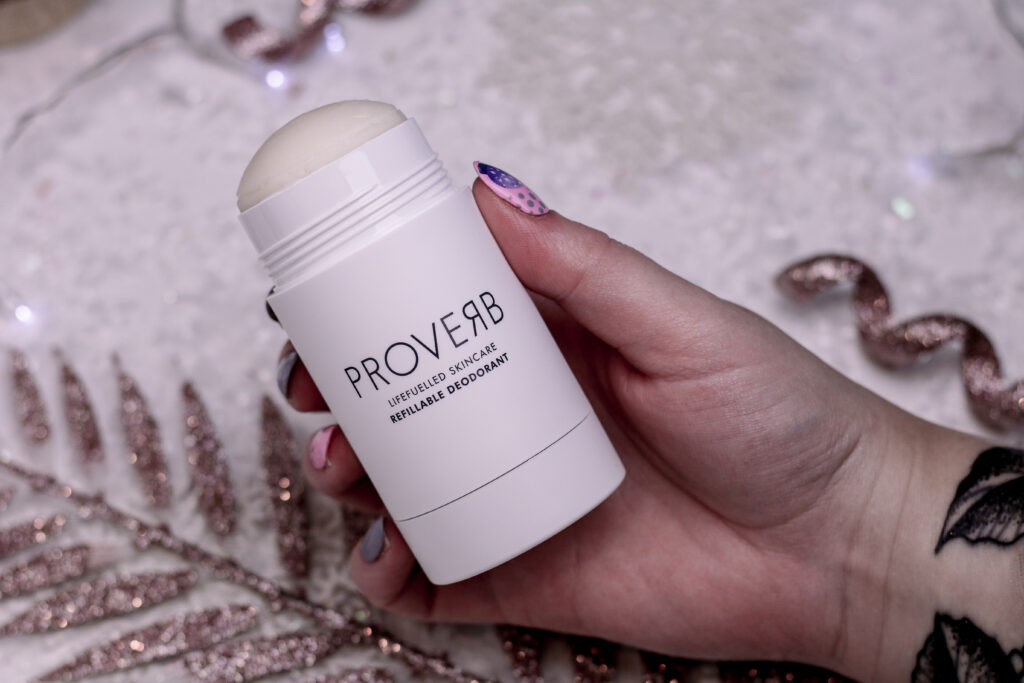 Close up photo of Jordanne holding the Proverb deodorant 