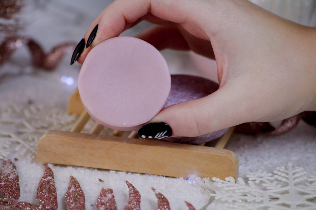 Close up of Jordanne holding the purple conditioner bar from nope