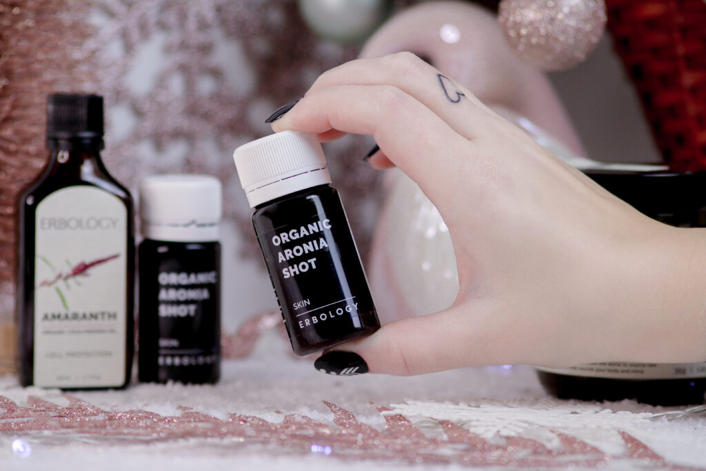 Close up of Jordanne holding an Erbology Organic Aronia Shot