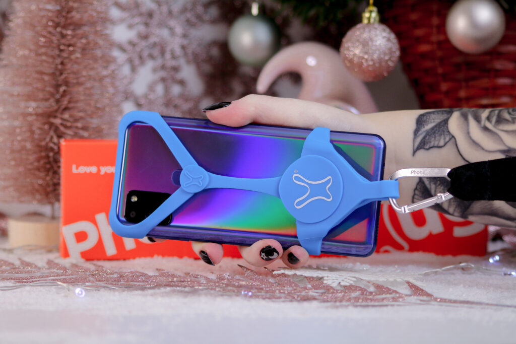 Close up photo of the PhoneHug in blue colour on a phone