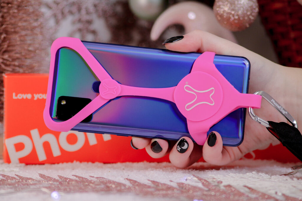 Close up photo of the PhoneHug in pink colour on a phone
