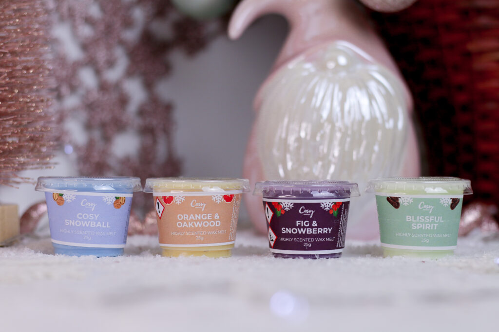 Close up of 4 wax melts from the Cosy Aromas Christmas Mini Melt Selection Box