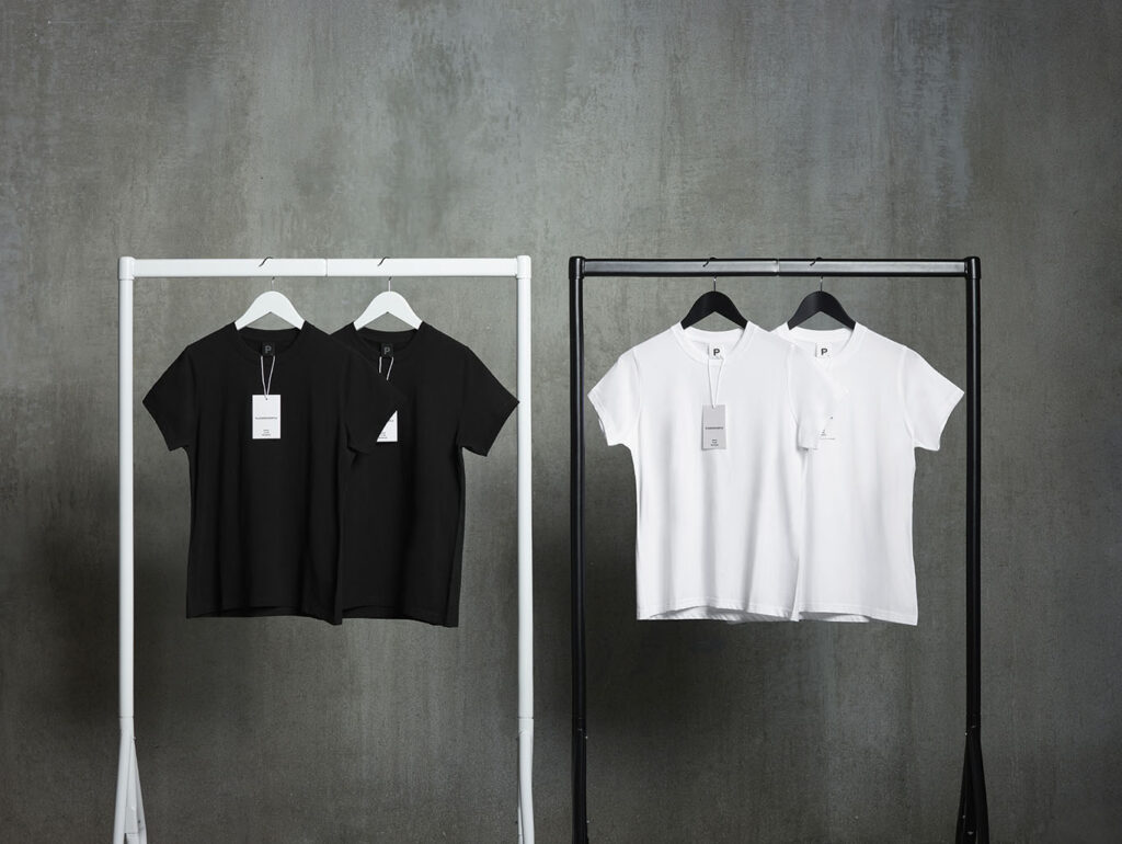A photo supplied by PLAINANDSIMPE of two black t-shirts and two white t-shirts on clothes racks