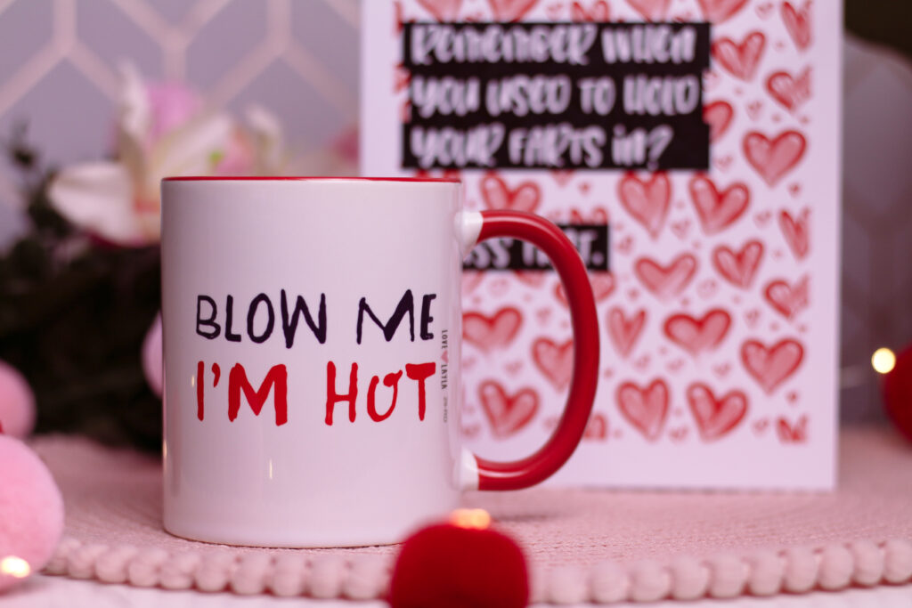 Close up of a mug from Love Layla that has " Blow me, I'm Hot" Written on it