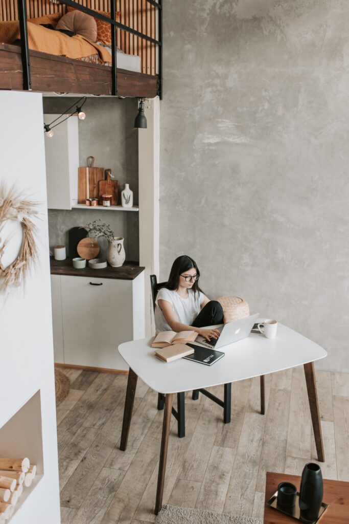 Stock photo from pexels by Vlada Karpovich of a woman sitting at a table working on a laptop