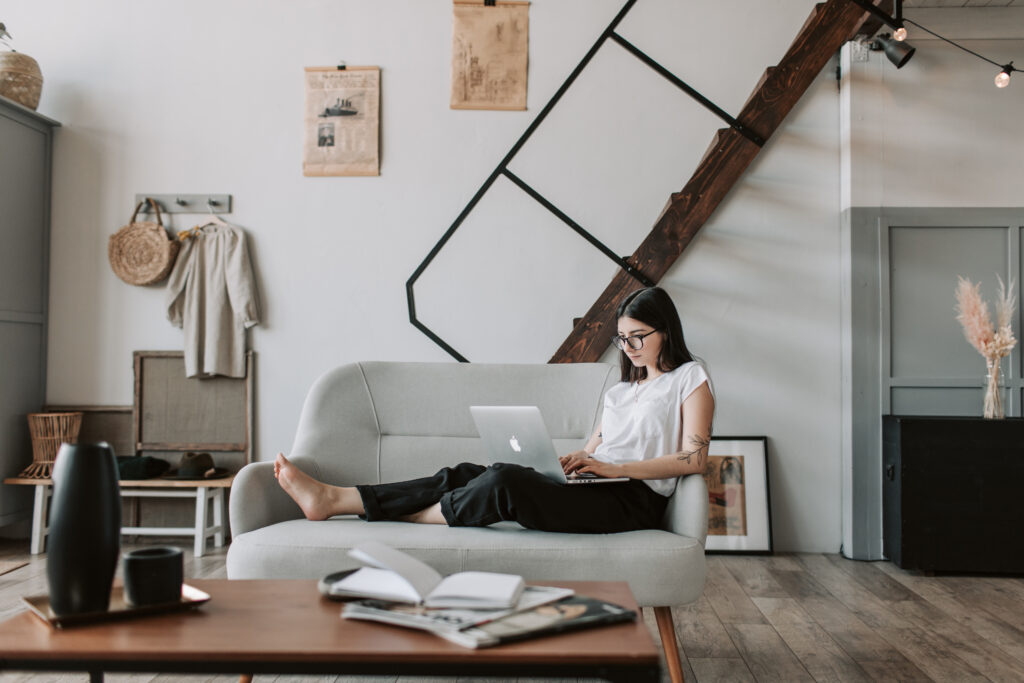 Stock photo from Pexels by Vlada Karpovich of a Content young woman using laptop in modern living room
