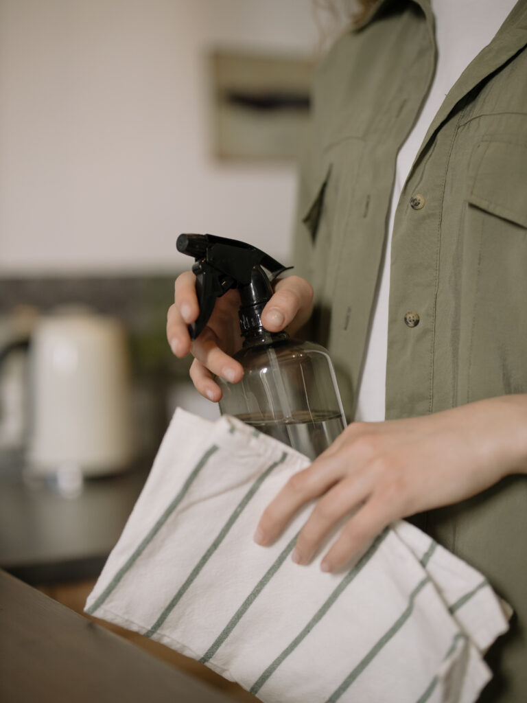Stock photo from Pexels by cottonbro of a Person Holding Black and Silver spray bottle and a cloth