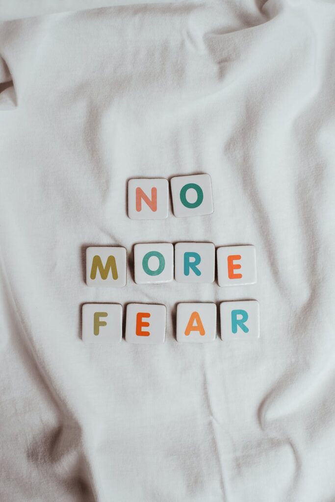 Stock photo from pexels by Vie Studio of The Phrase No More Fear on a Sheet of Fabric