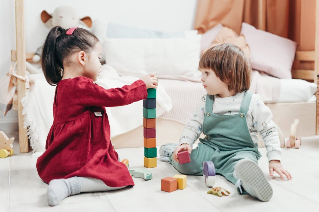 Stock photo from Pexels by Cottonbro of Two Children Playing With Lego Blocks and other Toys