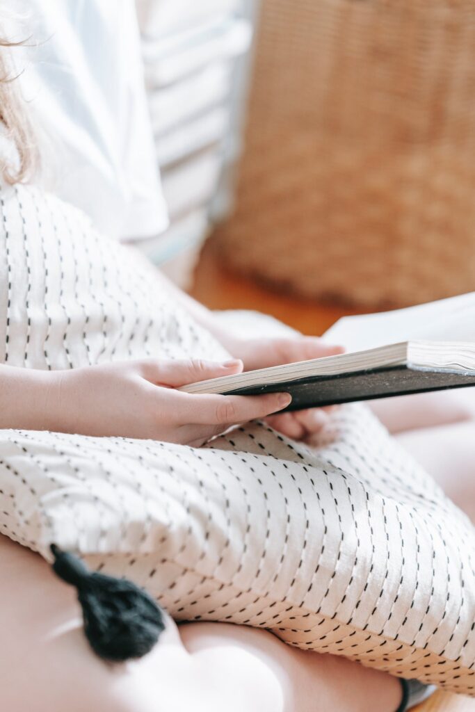 Stock photo from pexels by George Milton of a woman reading a journal