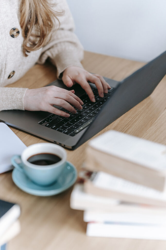 Stock photo from pexels by George Milton of a woman typing on laptop with a blue mug of coffee - Taking a Look at My May To-Do List | 2022