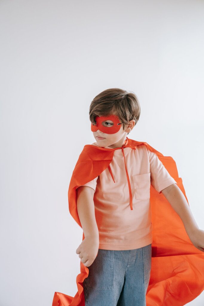Stock photo from Pexels by Katya Wolf of a Boy Wearing a Cape and a Mask