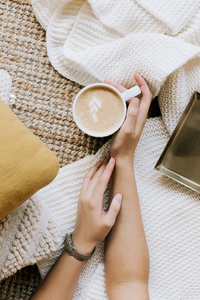 Stock photo from pexels by Ann poan of a mug of coffee on a white blanket as My June To-Do List | 2022 Edition main blog post image