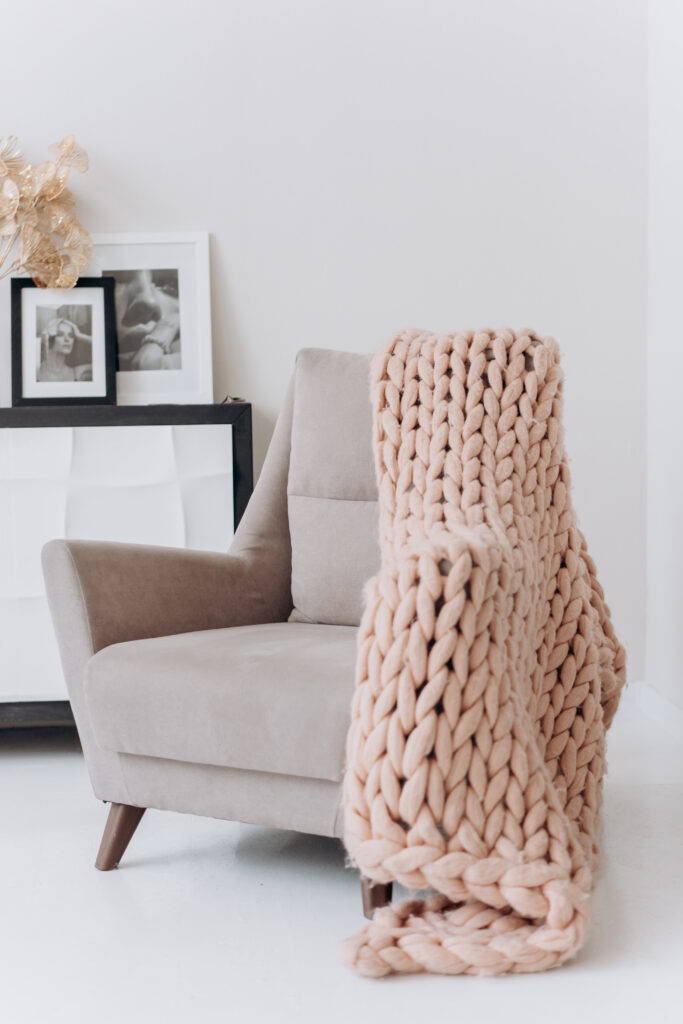 Stock photo from pexels by Mikhail Nilov of white and brown armchair beside white wall